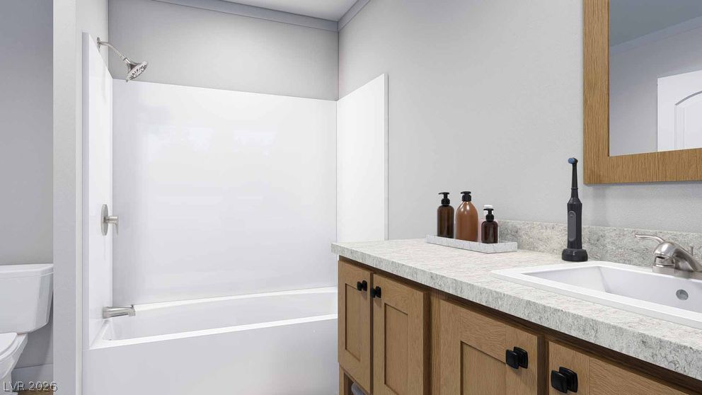 478 Box Canyon Road Alamo, NV 89001 - Photo 12 of 15 A classic bathtub shower combination sits adjacent to a wood vanity with stone counters.