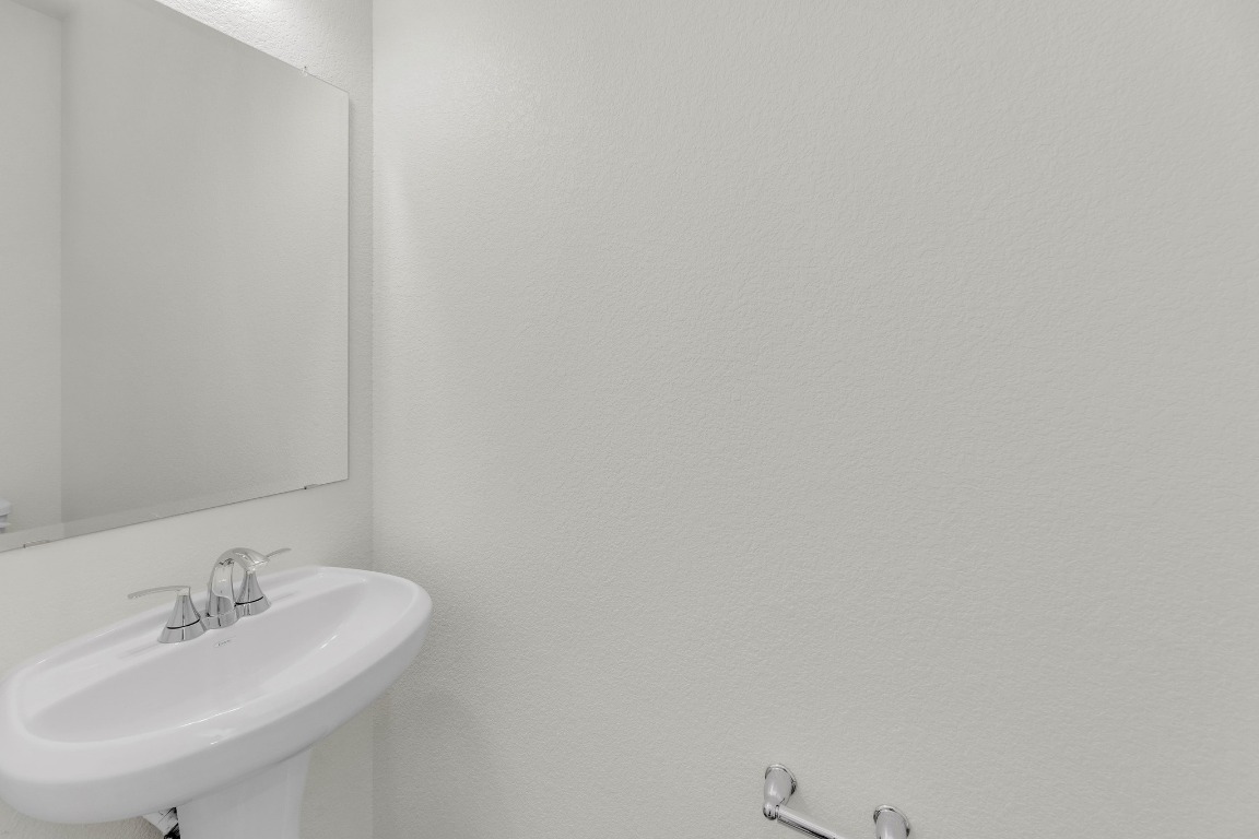 200 Lucky Texan Road Jarrell, TX 76537 - Photo 15 of 34 a bathroom with a sink and a mirror