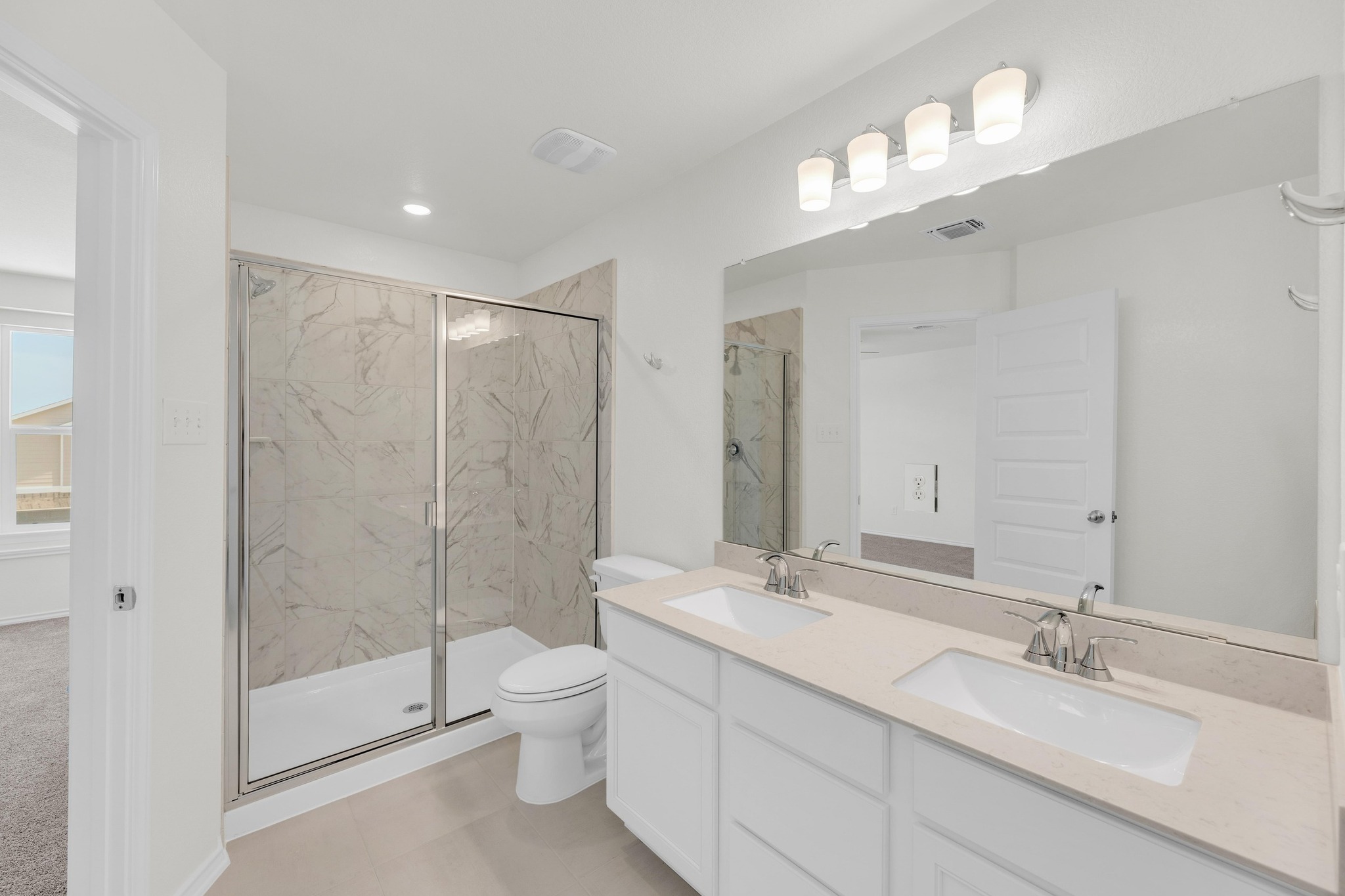 200 Lucky Texan Road Jarrell, TX 76537 - Photo 20 of 34 a bathroom with a double vanity sink mirror double shower and a toilet