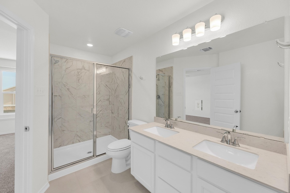 200 Lucky Texan Road Jarrell, TX 76537 - Photo 20 of 34 a bathroom with a double vanity sink toilet mirror and shower