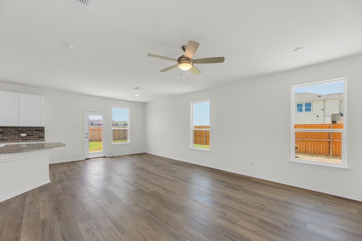 200 Lucky Texan Road Jarrell, TX 76537 - Photo 4 of 34 a view of an empty room with window and wooden floor