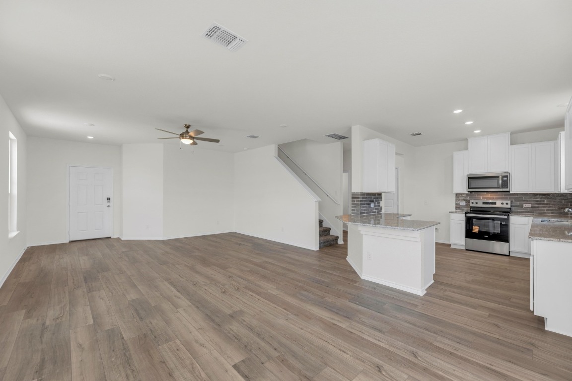 200 Lucky Texan Road Jarrell, TX 76537 - Photo 5 of 34 a view of a kitchen with stove and cabinets
