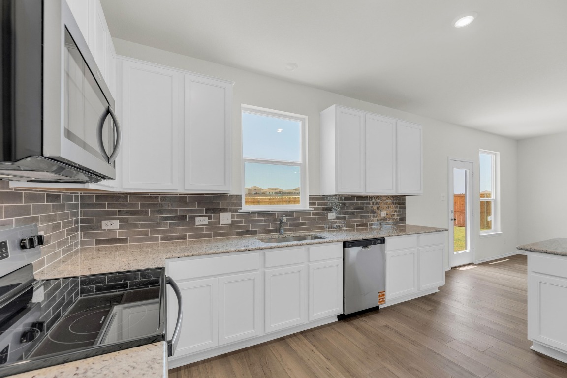 200 Lucky Texan Road Jarrell, TX 76537 - Photo 10 of 34 a kitchen with granite countertop a sink and cabinets
