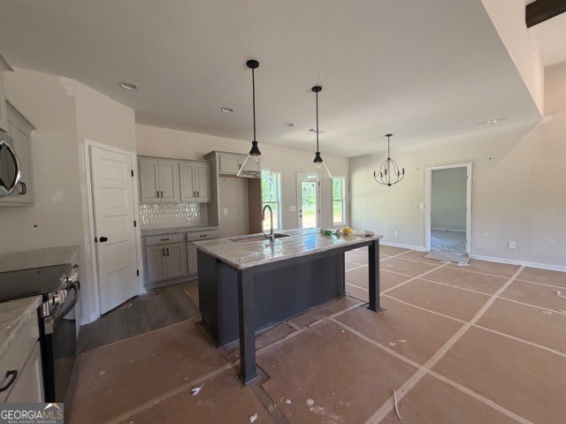 248 Robert Williams Road Pine Mountain, GA 31822 - Photo 11 of 46 a large kitchen with kitchen island a counter top space a sink stainless steel appliances and cabinets