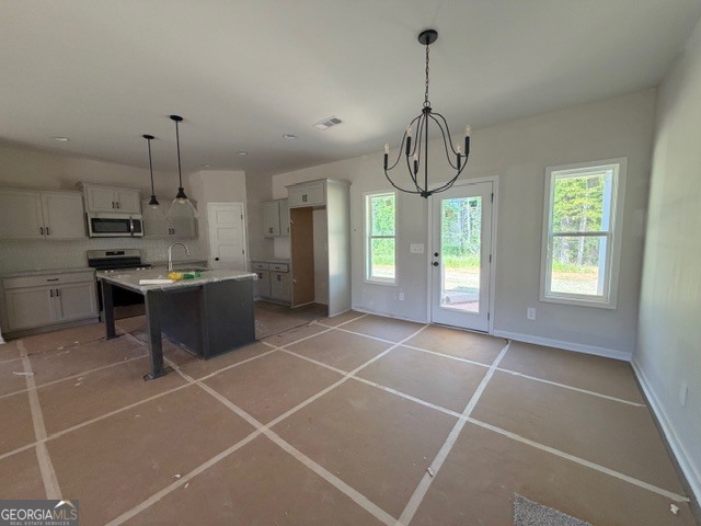 248 Robert Williams Road Pine Mountain, GA 31822 - Photo 8 of 46 a kitchen with stainless steel appliances a sink a counter top space cabinets and a window