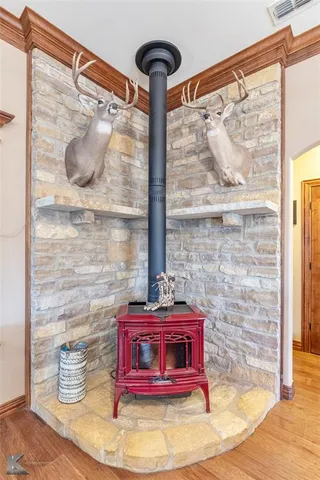 a red and white vase with flowers on it