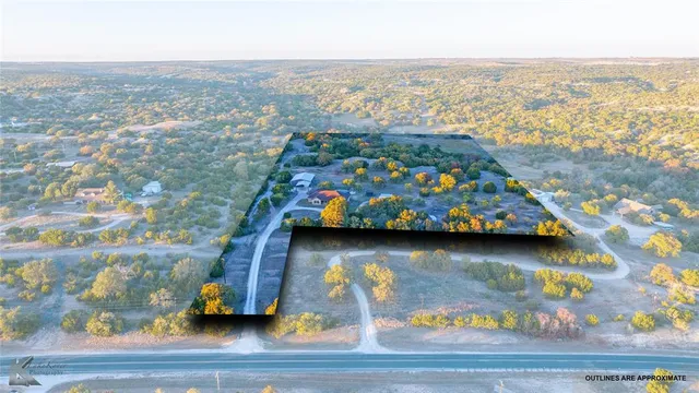 an aerial view of residential house with outdoor space and seating