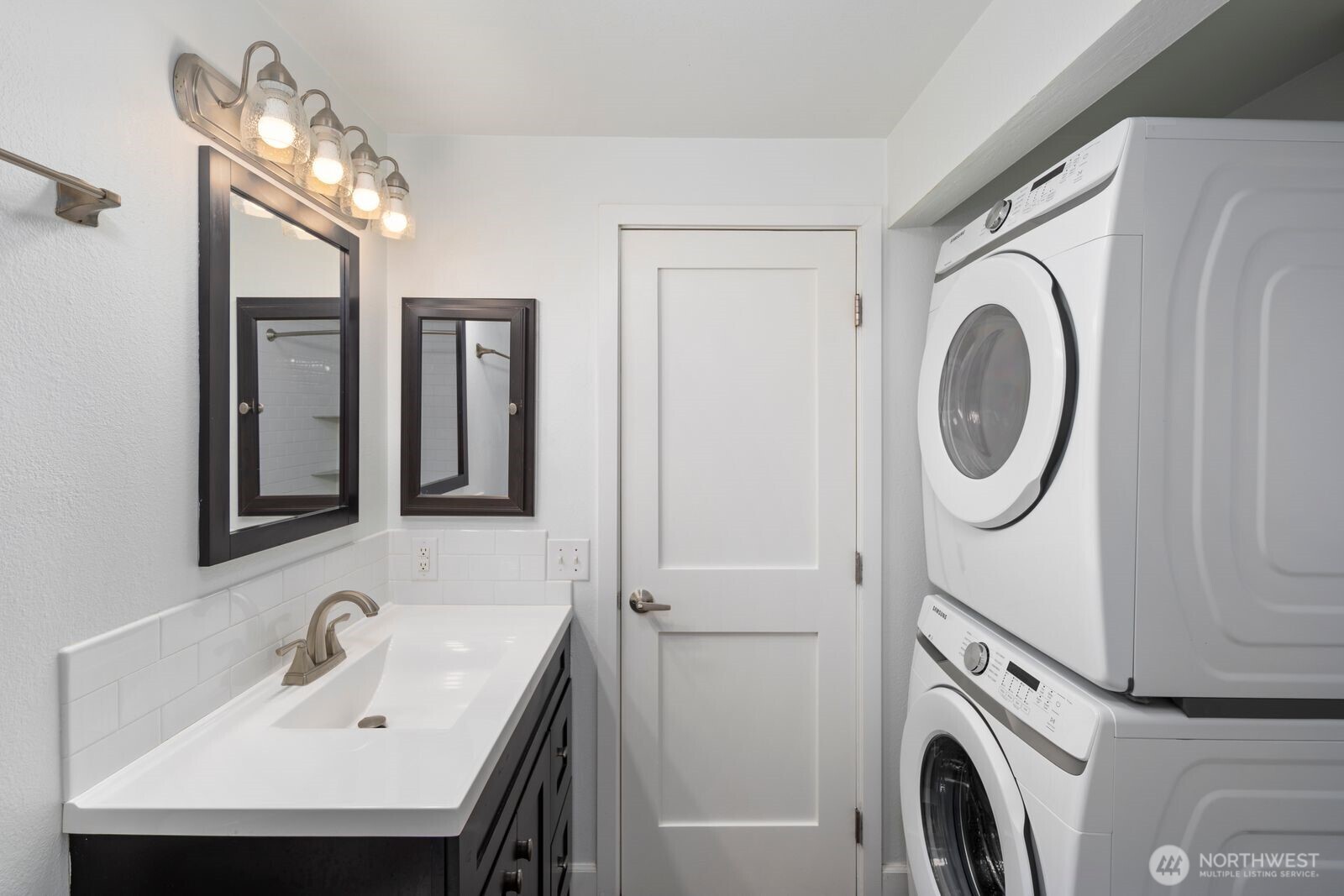 3901 Fremont Avenue North, Unit 202 Seattle, WA 98103 - Photo 15 of 23 a bathroom with a sink a washer and dryer