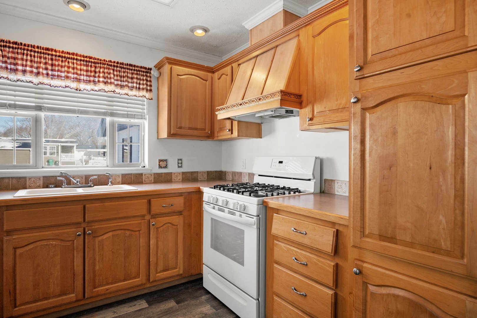 1119 Lakewood Road Elgin, IL 60123 - Photo 13 of 24 a kitchen with stainless steel appliances granite countertop a sink and cabinets