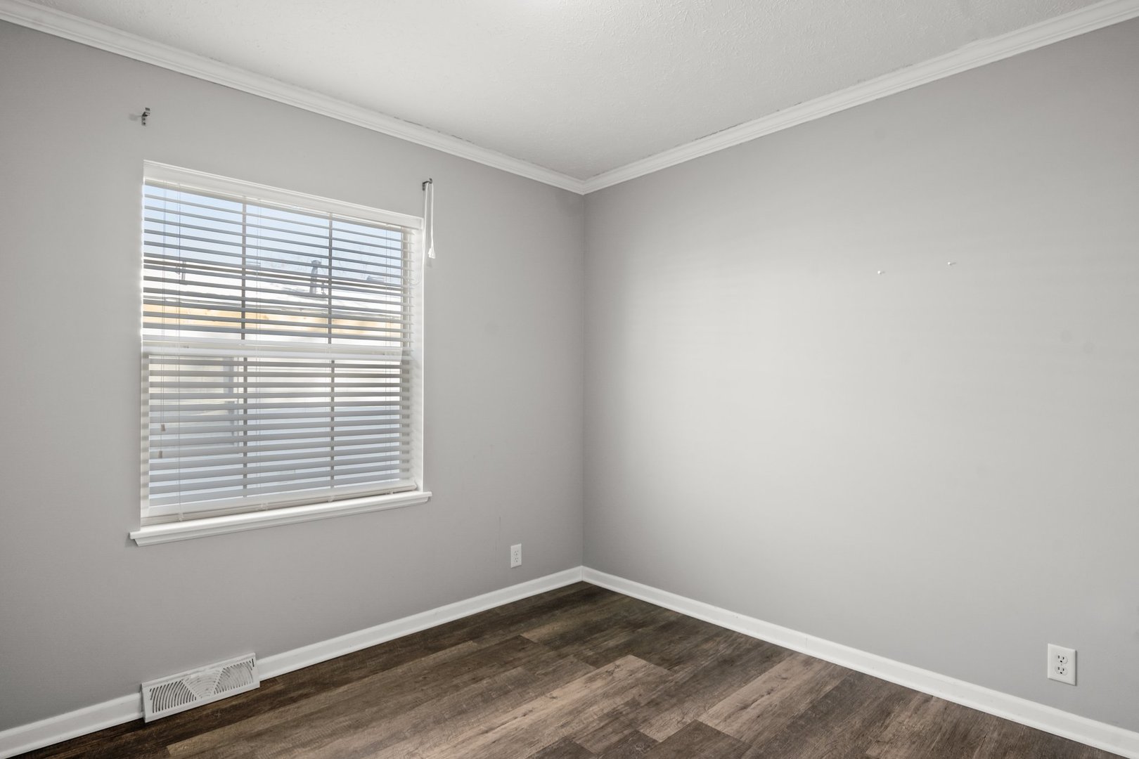1119 Lakewood Road Elgin, IL 60123 - Photo 20 of 24 a view of an empty room with wooden floor and a window
