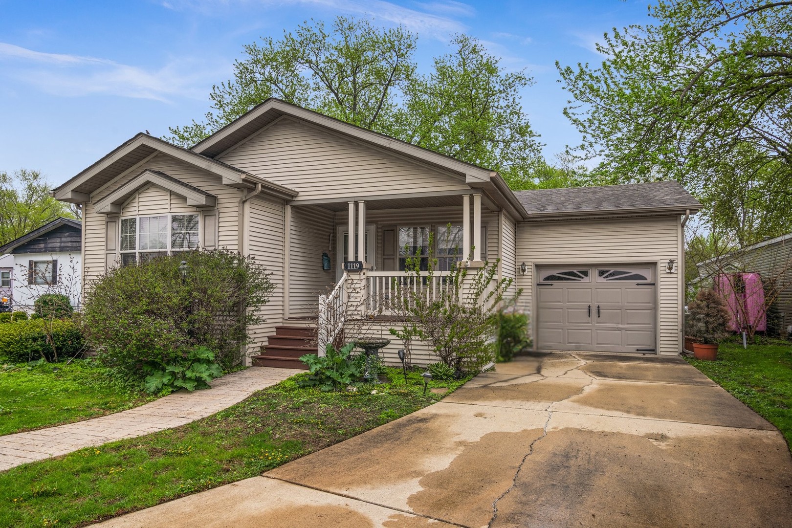 1119 Lakewood Road Elgin, IL 60123 - Photo 3 of 24 a front view of a house with a garden