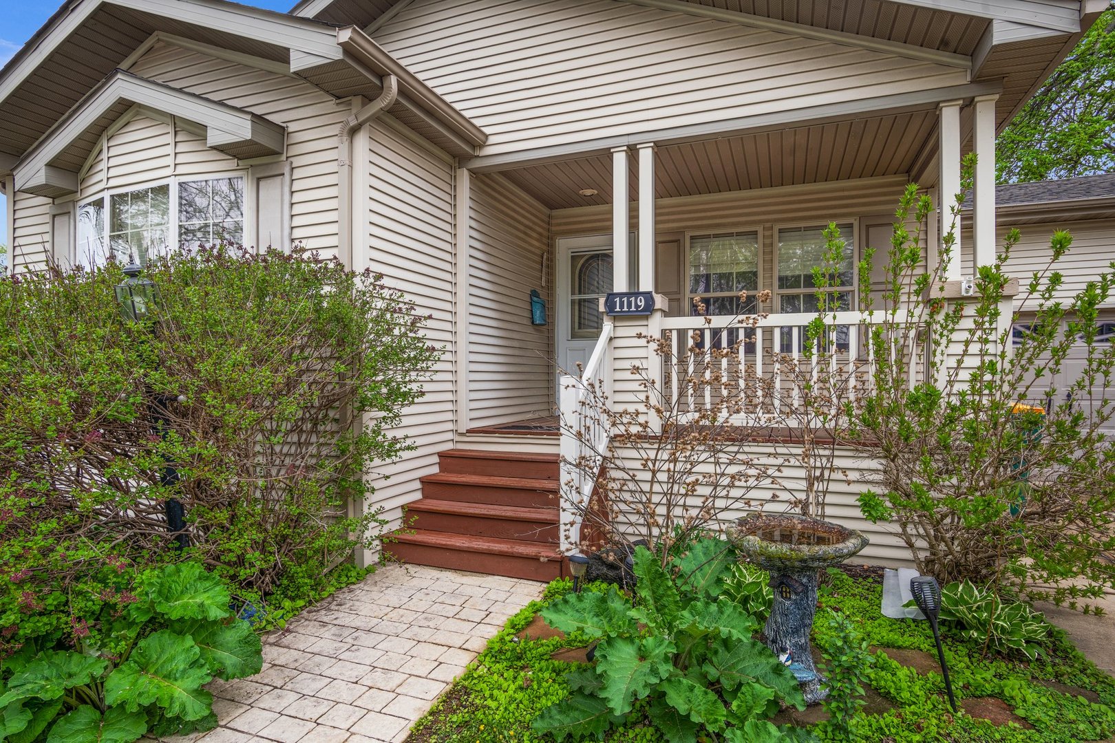 1119 Lakewood Road Elgin, IL 60123 - Photo 4 of 24 a front view of a house with a garden