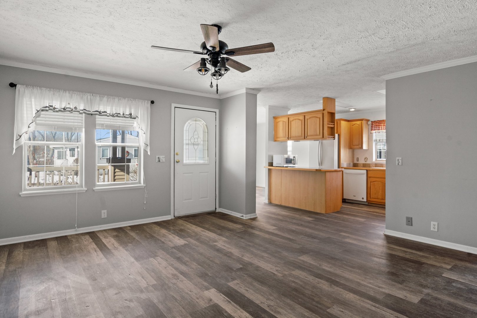 1119 Lakewood Road Elgin, IL 60123 - Photo 9 of 24 a view of an empty room with a window and wooden floor