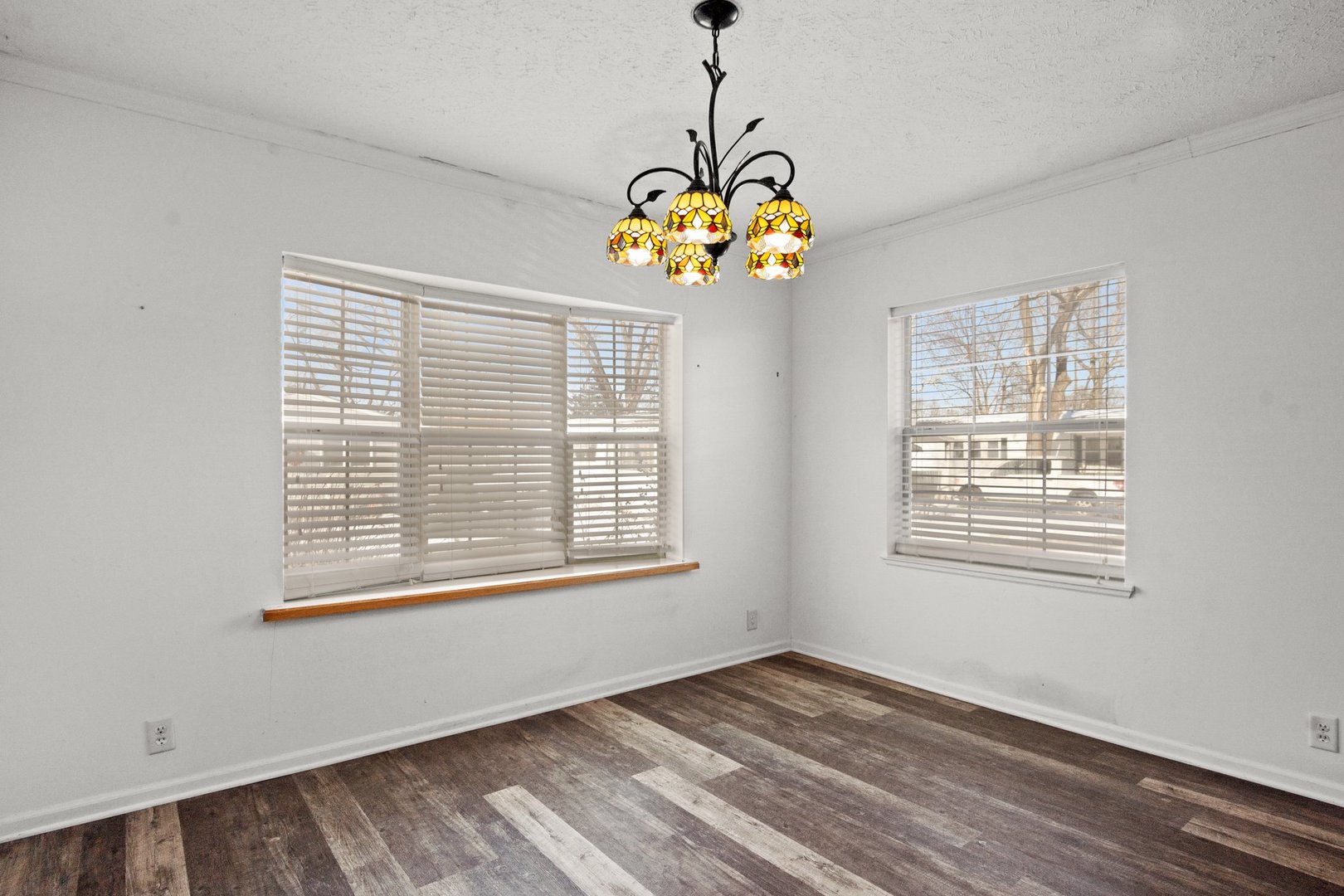 1119 Lakewood Road Elgin, IL 60123 - Photo 10 of 24 a view of an empty room with a window and wooden floor