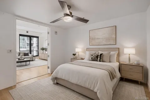 a bedroom with a large bed and a chandelier