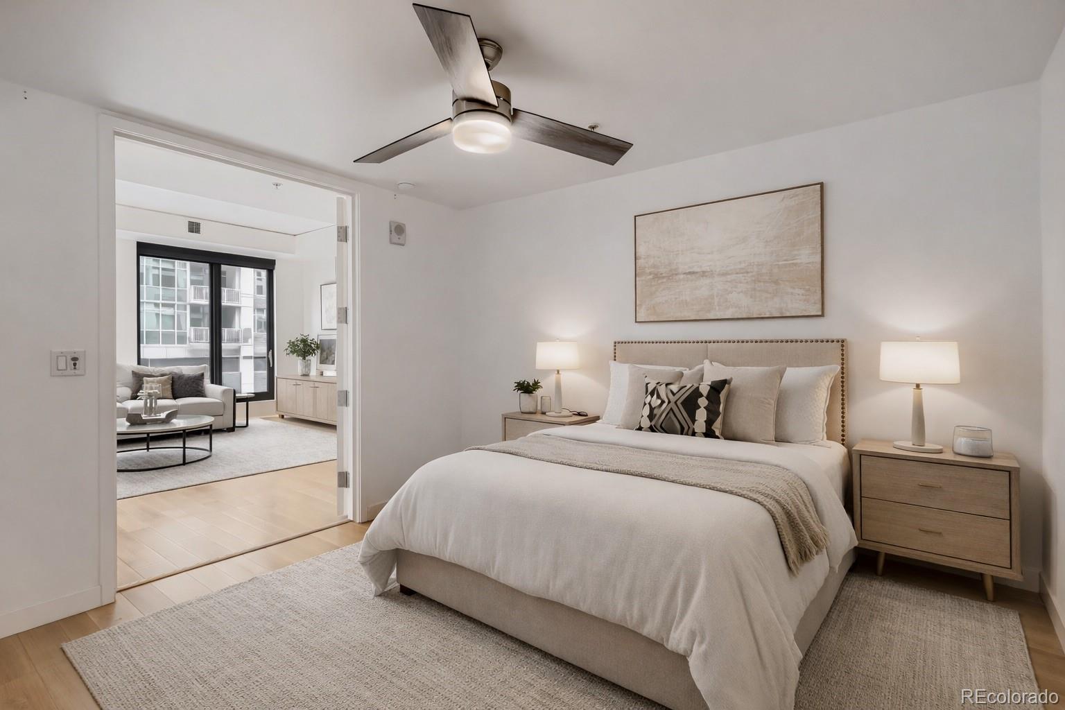 1750 Wewatta Street, Unit 403 Denver, CO 80202 - Photo 13 of 40 a bedroom with a large bed and a chandelier