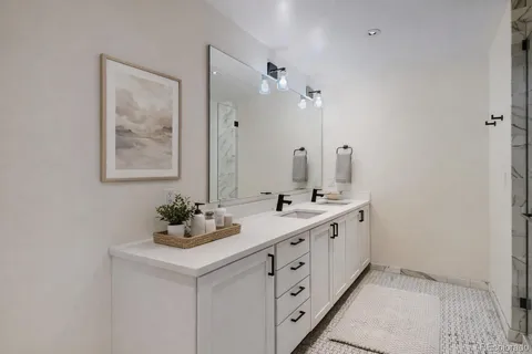 a bathroom with a double vanity sink mirror and