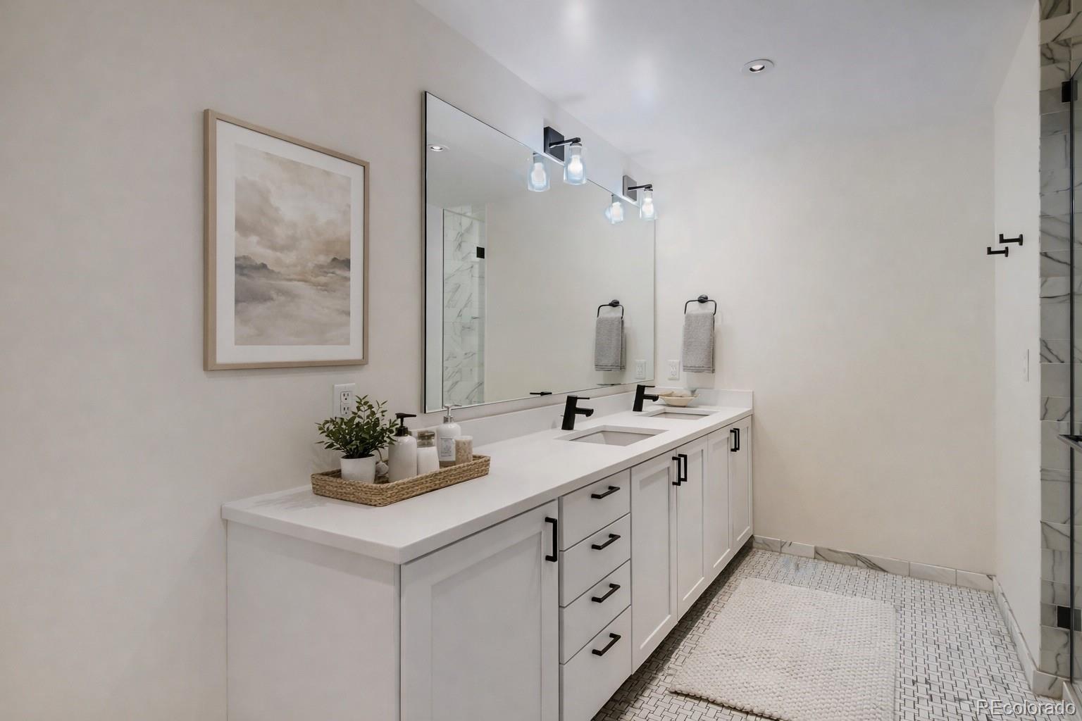 1750 Wewatta Street, Unit 403 Denver, CO 80202 - Photo 17 of 40 a bathroom with a double vanity sink mirror and