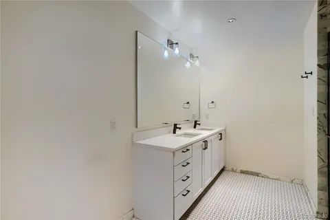 a bathroom with a double vanity sink and mirror