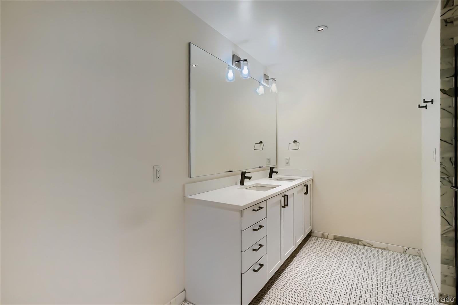 1750 Wewatta Street, Unit 403 Denver, CO 80202 - Photo 18 of 40 a bathroom with a double vanity sink and mirror