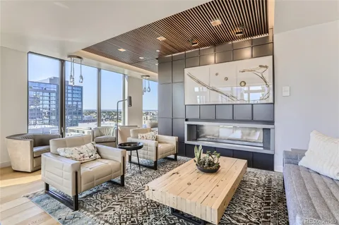 a dining hall with couches a dining table chairs and a large window