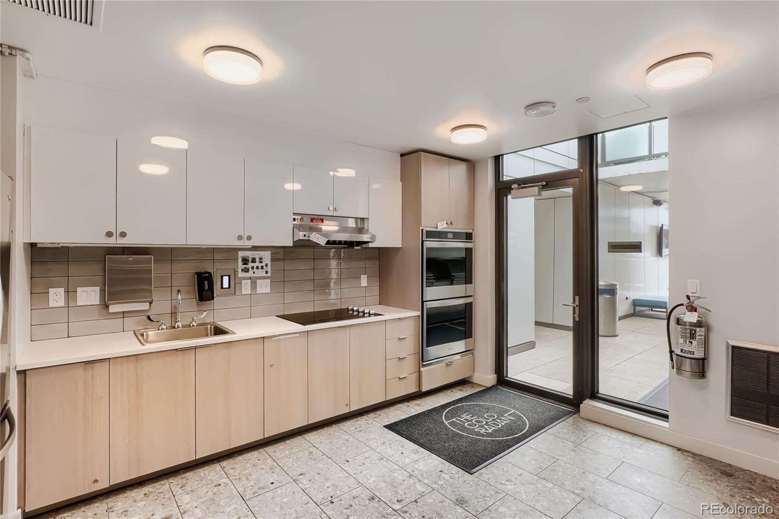 1750 Wewatta Street, Unit 403 Denver, CO 80202 - Photo 32 of 40 a kitchen with stainless steel appliances a sink stove refrigerator and cabinets