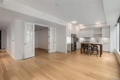 a view of kitchen with refrigerator and chairs