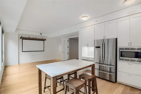 a kitchen with stainless steel appliances a refrigerator and a stove top oven