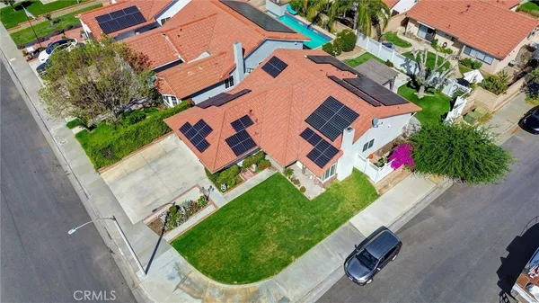 an aerial view of a house with a garden and swimming pool