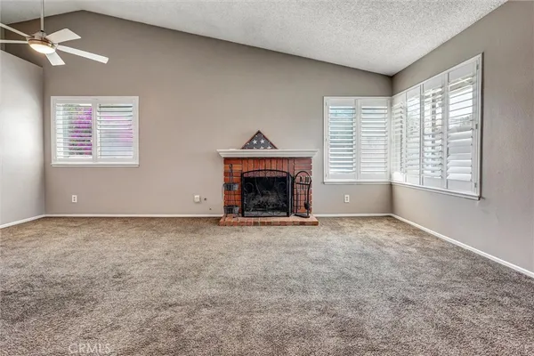 a view of empty room with a fireplace