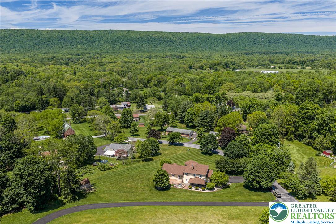 947 Tamenend Road Bath, PA 18014 - Photo 55 of 61 An aerial panorama reveals a private estate nestled amongst lush greenery and rolling hills.
