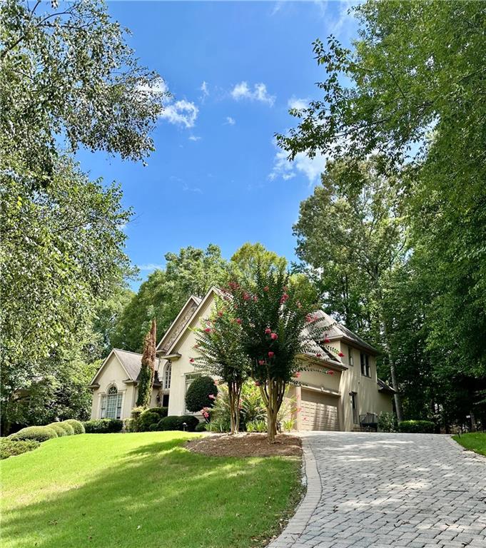 1032 Laurel Grove Court Suwanee, GA 30024 - Photo 2 of 3 a view of house with a yard