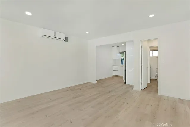 a view of an empty room with a kitchen