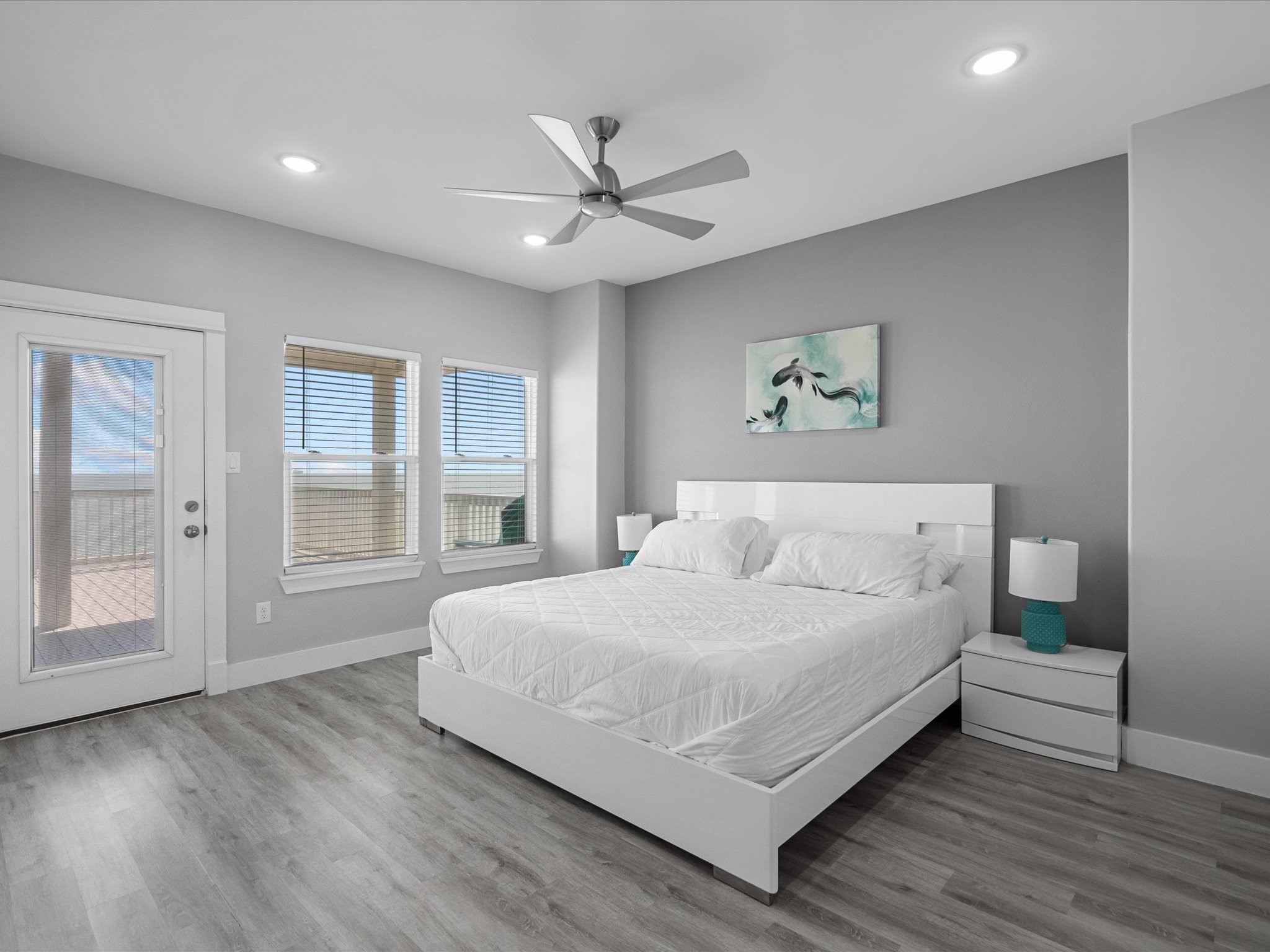 718 Beach Drive Surfside Beach, TX 77541 - Photo 39 of 49 Experience a modern, inviting bedroom featuring stylish bunk beds with vibrant accents. The sleek gray walls, recessed lighting, and wood-like flooring enhance its bright and welcoming appeal, making it perfect for children or guests.