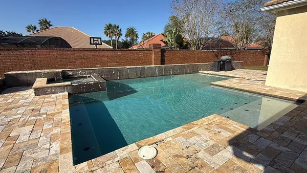 a view of a backyard with sitting area