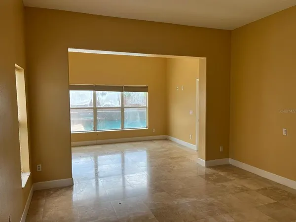 a view of an empty room with a window