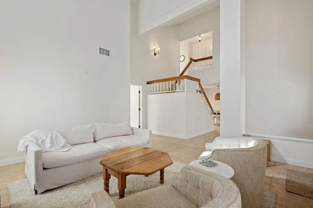 a living room with furniture and a gym