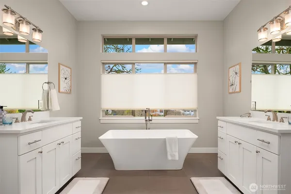 a room with counter top space a sink a lamp a window and a shower