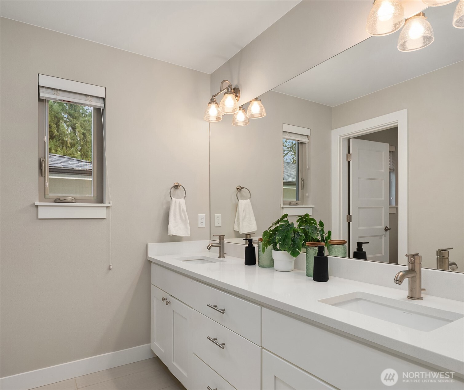 4529 327th Place Northeast Carnation, WA 98014 - Photo 20 of 27 a bathroom with a sink a potted plant and a mirror