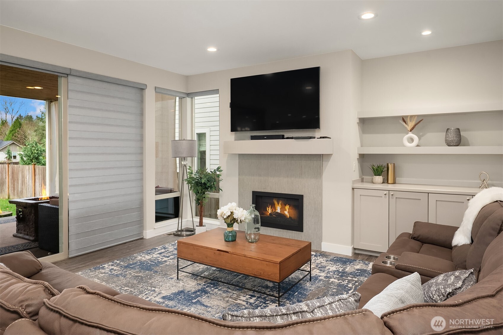 4529 327th Place Northeast Carnation, WA 98014 - Photo 3 of 27 a living room with furniture a flat screen tv and a fireplace