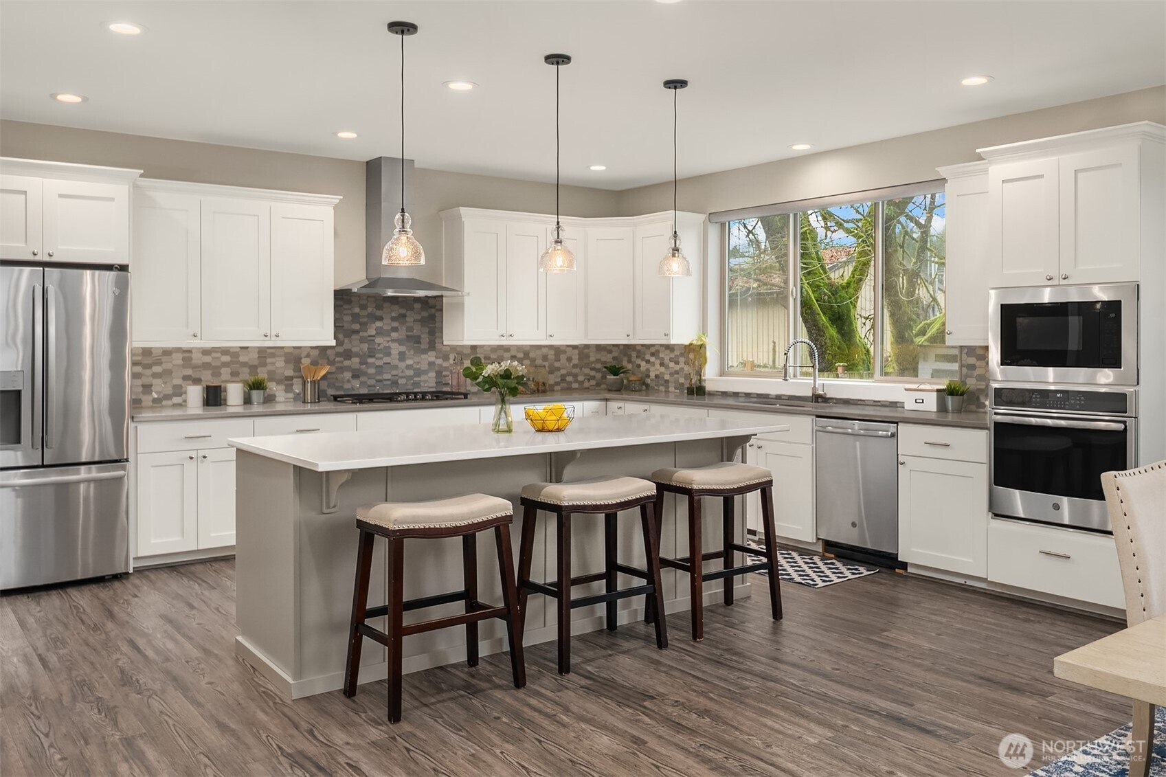 4529 327th Place Northeast Carnation, WA 98014 - Photo 5 of 27 a kitchen with a table chairs microwave and cabinets