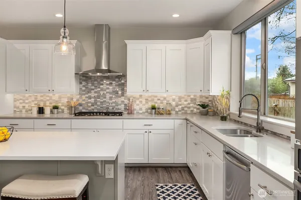 a kitchen with a sink cabinets and window