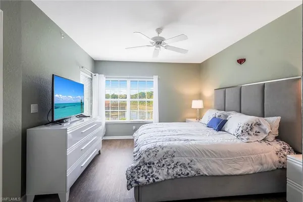 a bedroom with a large bed and a chandelier