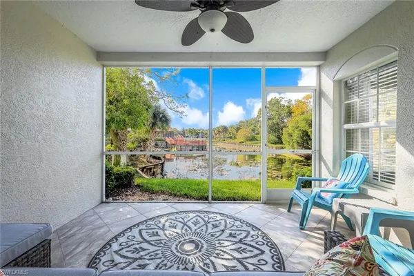 a view of a patio with a table chairs and a potted plant