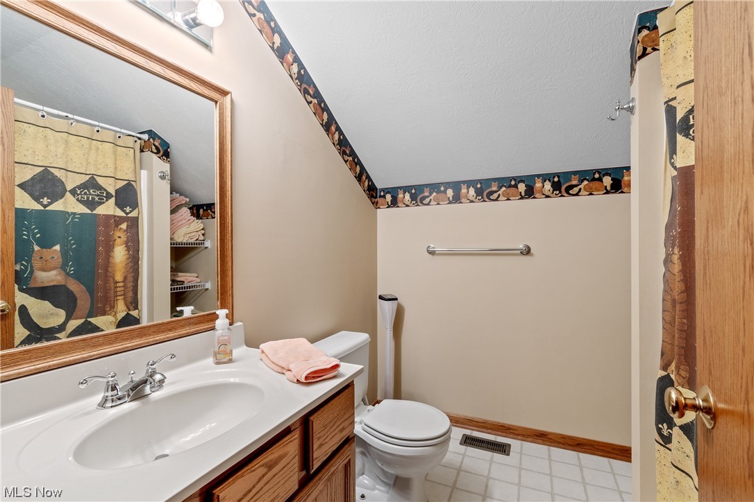 2428 Charing Cross Road Northwest Canton, OH 44708 - Photo 26 of 35 Second floor full bath features vaulted ceiling and tub and shower combo.