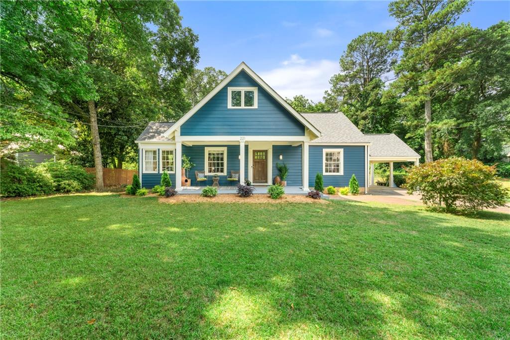 221 Forkner Drive Decatur, GA 30030 - Photo 1 of 1 a front view of a house with a yard table and chairs