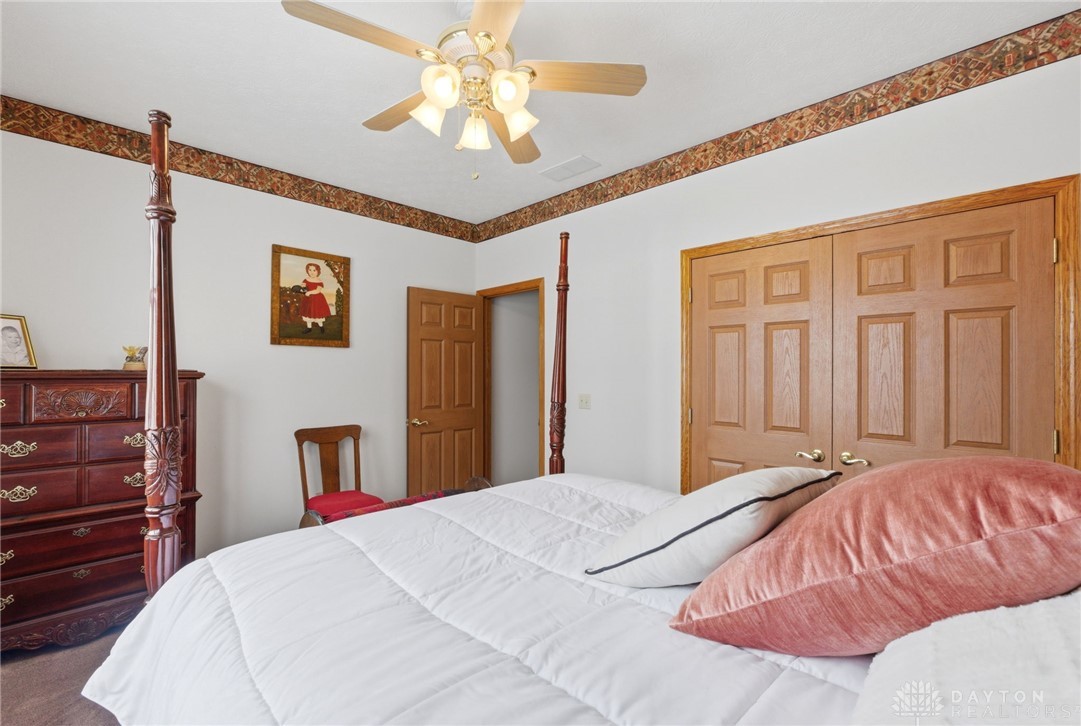 1540 Jasper Road Xenia, OH 45385 - Photo 39 of 91 This spacious bedroom features classic wood doors and an elegant ceiling fan.