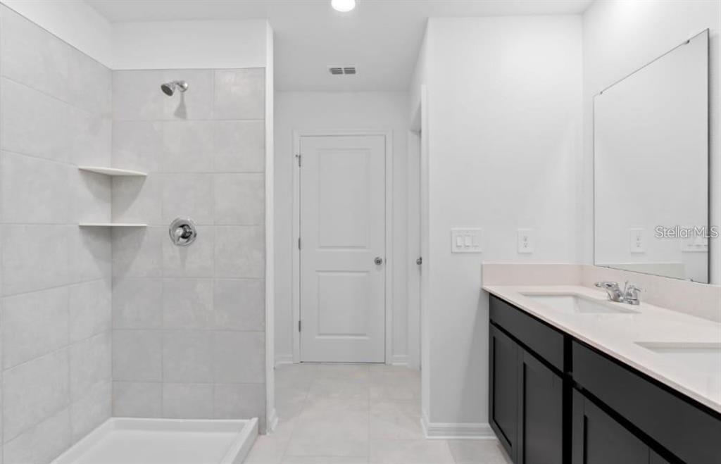 669 Reggie Road Winter Haven, FL 33859 - Photo 13 of 23 a bathroom with a sink and a mirror