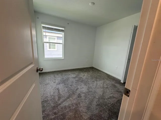 an empty room with a empty space and windows