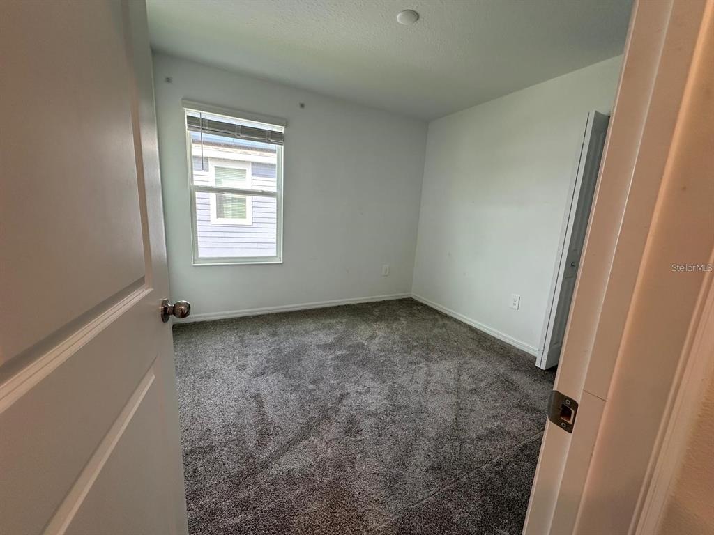 669 Reggie Road Winter Haven, FL 33859 - Photo 16 of 23 an empty room with a empty space and windows